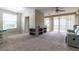 Living room with recessed shelving, carpet, and access to patio at 4555 Sw 52Nd Cir # 101, Ocala, FL 34474