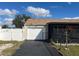 Single car garage with driveway and white vinyl fence at 1 Willow Ct, Ocala, FL 34472