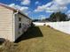 Spacious backyard with a large grassy area and white vinyl fence at 1 Willow Ct, Ocala, FL 34472
