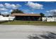 Ranch-style home with covered porch and landscaped yard at 1 Willow Ct, Ocala, FL 34472