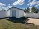 White vinyl storage shed with roll-up door at 1 Willow Ct, Ocala, FL 34472