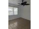 Well-lit bedroom with ceiling fan and tile flooring at 1 Willow Ct, Ocala, FL 34472