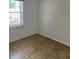 Simple bedroom with tile flooring and large window at 1 Willow Ct, Ocala, FL 34472
