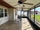 Relaxing screened porch with tile flooring and ceiling fans at 1 Willow Ct, Ocala, FL 34472