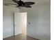 Spacious bedroom with ceiling fan and access to another room at 1 Willow Ct, Ocala, FL 34472