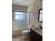 Clean bathroom with a shower/tub combo, vanity, and floral wallpaper at 1 Willow Ct, Ocala, FL 34472