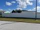 Vacant lot with white vinyl fence and adjacent properties at 1 Willow Ct, Ocala, FL 34472