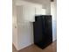 Kitchen area with white cabinets and black refrigerator at 1 Willow Ct, Ocala, FL 34472