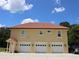 Three-car garage with white doors and a tan exterior at 1485 & 1525 Se 59Th St, Ocala, FL 34480