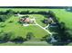 Aerial view of two large homes on a spacious lot with lush landscaping at 1485 & 1525 Se 59Th St, Ocala, FL 34480