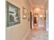 Bright hallway with artwork and travertine flooring at 1485 Se 59Th St, Ocala, FL 34480