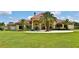 Grand estate home with tile roof, arched entry, and lush landscaping at 1485 Se 59Th St, Ocala, FL 34480