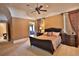 Spacious bedroom with carpeted floors, ceiling fan and ensuite bathroom at 1485 Se 59Th St, Ocala, FL 34480