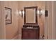Elegant powder room with dark wood vanity and ornate mirror at 1485 Se 59Th St, Ocala, FL 34480