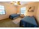 Bedroom with twin beds, carpet floors, and a ceiling fan at 3630 Ne 67Th Ter, Silver Springs, FL 34488