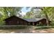 Ranch style home with wood siding and landscaping at 3630 Ne 67Th Ter, Silver Springs, FL 34488