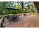 Spacious wooden deck with patio furniture, perfect for outdoor dining at 3630 Ne 67Th Ter, Silver Springs, FL 34488