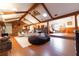Open concept living area showcasing high ceilings, wood beams, and a cozy fireplace at 3630 Ne 67Th Ter, Silver Springs, FL 34488
