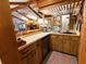 Rustic wet bar featuring wood cabinetry, wine glass racks, and a small refrigerator at 3630 Ne 67Th Ter, Silver Springs, FL 34488
