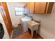Laundry room with washer, dryer, and utility sink at 3630 Ne 67Th Ter, Silver Springs, FL 34488