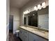 Bathroom with double vanity, granite countertop, and a walk-in shower at 4489 Sw 90Th Pl, Ocala, FL 34476