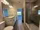 Bathroom featuring double sinks, granite counters, and a walk-in shower at 4489 Sw 90Th Pl, Ocala, FL 34476