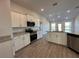 Island kitchen with granite countertops and stainless steel appliances at 4489 Sw 90Th Pl, Ocala, FL 34476