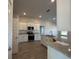 Modern kitchen with white cabinets, granite counters, and stainless steel appliances at 4489 Sw 90Th Pl, Ocala, FL 34476