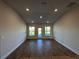 Spacious living area with wood-look tile floors and access to the patio at 4489 Sw 90Th Pl, Ocala, FL 34476