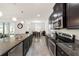 Modern kitchen featuring dark cabinetry, granite countertops, and stainless steel appliances at 4710 Sw 65Th Pl, Ocala, FL 34474