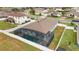 An aerial view of a house with a screened-in pool and fenced backyard at 4710 Sw 65Th Pl, Ocala, FL 34474