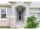 Inviting front entry with stone accents and a dark-colored door at 4710 Sw 65Th Pl, Ocala, FL 34474