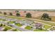 Aerial view showcasing a community of houses with a road and green space at 4710 Sw 65Th Pl, Ocala, FL 34474
