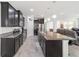 Open kitchen with dark cabinetry, granite counters and island at 4710 Sw 65Th Pl, Ocala, FL 34474