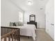 Spacious bedroom with a queen-size bed and crib at 4710 Sw 65Th Pl, Ocala, FL 34474