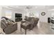 Spacious living room featuring comfortable sofas, a large TV, and tile floors at 4710 Sw 65Th Pl, Ocala, FL 34474