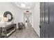 Bright entryway with tile floor, console table, and comfortable chair at 4710 Sw 65Th Pl, Ocala, FL 34474