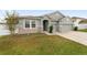 Two-story house with gray siding, stone accents, and a two-car garage at 4710 Sw 65Th Pl, Ocala, FL 34474