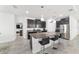 Modern kitchen with dark cabinets, granite countertops, and island seating at 4710 Sw 65Th Pl, Ocala, FL 34474