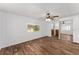 Bright bedroom with ceiling fan, wood-look flooring, and mirrored closet doors at 903 Aloha Way, Lady Lake, FL 32159