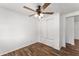 Bedroom with ceiling fan, built-in drawers and wood-look flooring at 903 Aloha Way, Lady Lake, FL 32159