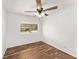 Spacious bedroom with ceiling fan and wood-look flooring at 903 Aloha Way, Lady Lake, FL 32159