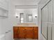 Bathroom with single vanity, wood cabinets and tub shower combo at 903 Aloha Way, Lady Lake, FL 32159