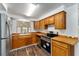 Modern kitchen with stainless steel appliances and wood cabinets at 903 Aloha Way, Lady Lake, FL 32159