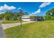 Mobile home with carport and a well-kept lawn at 903 Aloha Way, Lady Lake, FL 32159