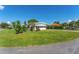 Mobile home with carport and a well-kept lawn at 903 Aloha Way, Lady Lake, FL 32159