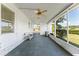 Screened porch with ceiling fan and view of backyard at 903 Aloha Way, Lady Lake, FL 32159