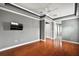 Bright bedroom with hardwood floors and a mounted TV at 9450 Se 130Th Place Rd, Summerfield, FL 34491