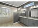 Spa-like bathroom with a walk-in shower and double vanity at 9450 Se 130Th Place Rd, Summerfield, FL 34491
