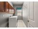 Laundry room with washer, dryer, cabinets and shelving at 9450 Se 130Th Place Rd, Summerfield, FL 34491